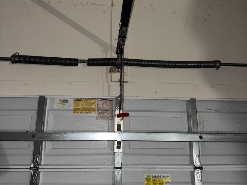 Torsion spring and center bracket on the bar above a steel garage door